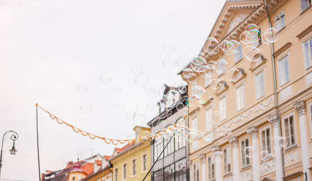 Soap bubbles on background of old town of Ljubljanaの写真素材