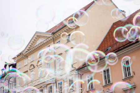 Soap bubbles on background of old town of Ljubljanaの写真素材
