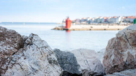 landscape with stones and red lighthouse in the seaの写真素材