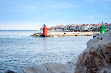 landscape with stones and red lighthouse in the seaの写真素材