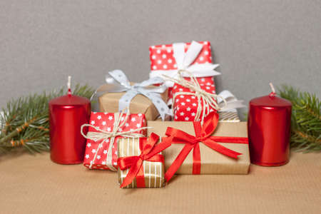 pile of christmas gifts candles and fir-tree branchesの写真素材