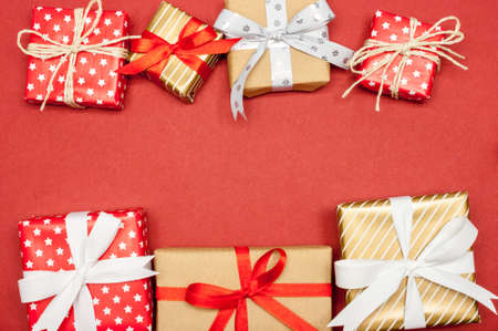many different christmas presents on red paper backgroundの写真素材