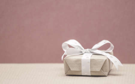 one small christmas gift on red backgroundの写真素材