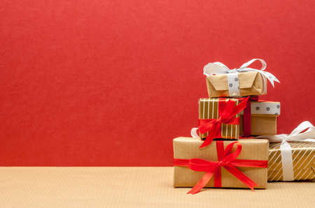 pile of different beautiful christmas gifts on red background