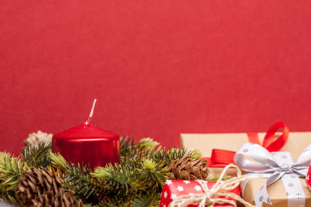 pile of christmas gifts candles and fir-tree branches