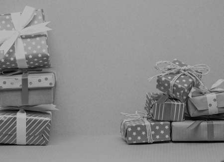 black and white two piles of different christmas giftsの写真素材