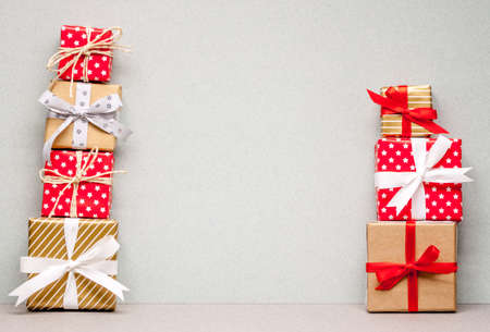 two piles of different christmas gifts on craft paperの写真素材