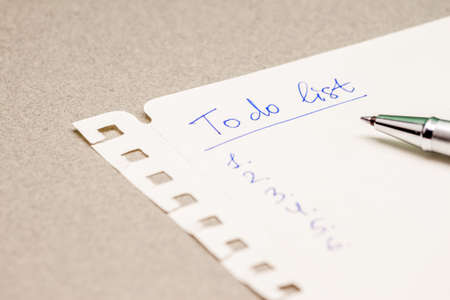 to do list and pen on grey background