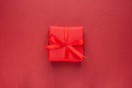 gift box with bow knot on red craft backgroundの写真素材
