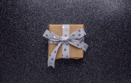 one small craft brown gift on black backgroundの写真素材