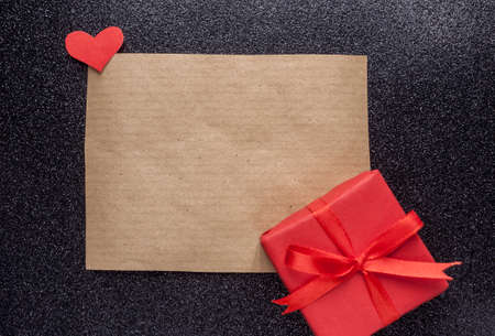 brown piece of paper and red gift