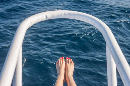 wooman feet on white yacht bowの写真素材