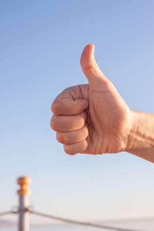 male hand showing thumbs upの写真素材