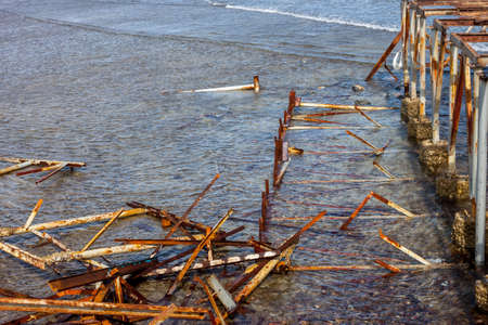old damaged pier garbage in waterの写真素材