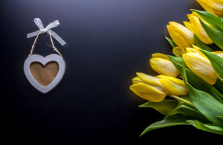 yellow tulips and wooden heartの写真素材