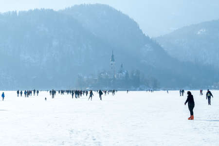 frozen lake Bled many people on iceの写真素材
