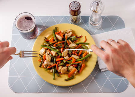 vegetables with meat on yellow plateの写真素材