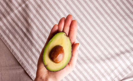avocado in women hand