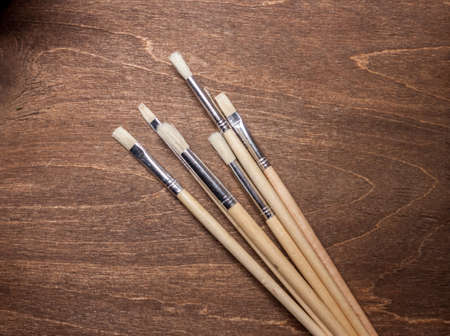 brushers on brown wooden background