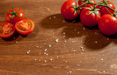 fresh ripe cherry tomatoes on wooden backgroundの写真素材