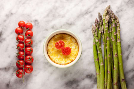 asparagus cherry tomatoes casserole marble backgroundの写真素材
