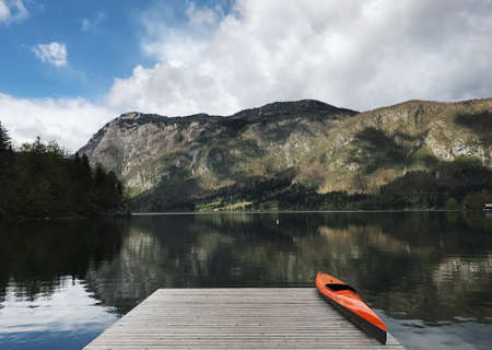 Mountain lake orange kayak mobile photoの写真素材