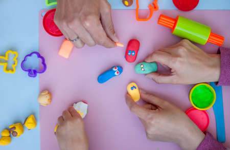 hands playing with plasticine toysの写真素材