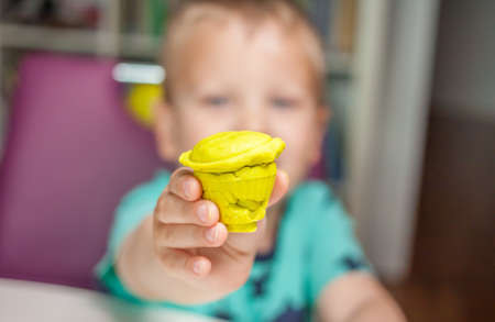 cute little boy playing with plasticine