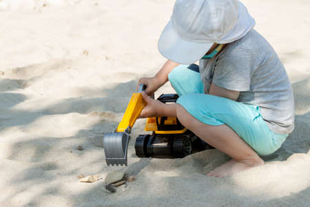 little boy playing with toy excavatorの写真素材