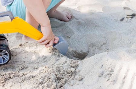 little boy playing with toy excavatorの写真素材