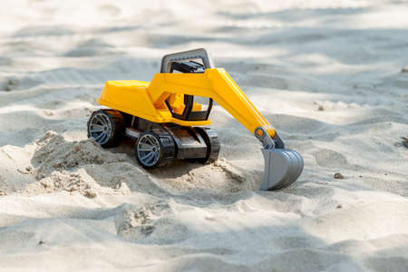 toy excavator digging sandの写真素材