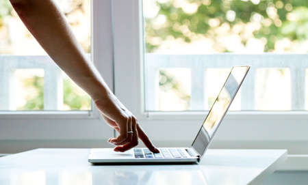 laptop computer female finger pressing the keyの写真素材