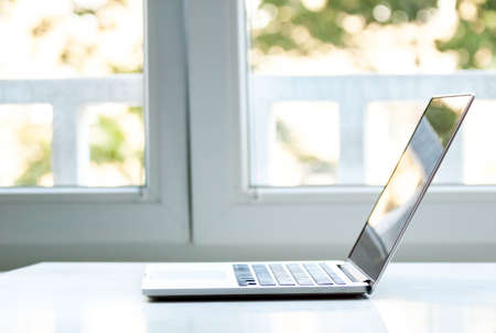 laptop computer near the window