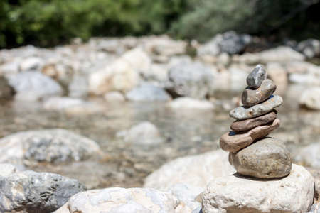 balancing stones on the mountain river