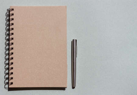 top view craft notebook and pen on blue backgroundの写真素材