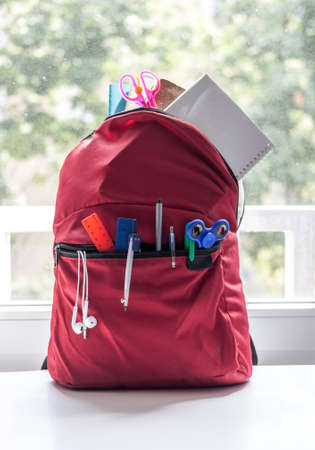 red backpack with school suppliesの写真素材