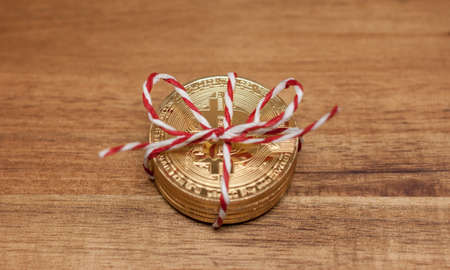 golden bitcoin coins wrapped as giftの写真素材