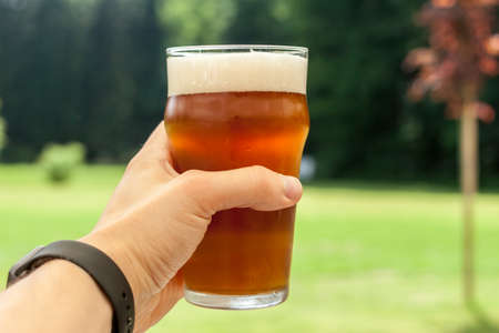 vacation concept hand with glass of beerの写真素材