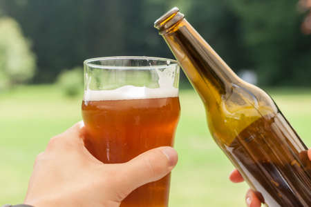 cheers glass and bottle of beerの写真素材