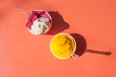 ice cream in paper cups orange tableの写真素材