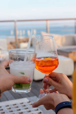 cheers two glasses with cocktailsの写真素材