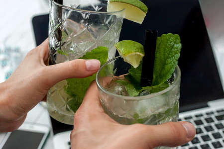 two glasses of mojito on laptop backgroundの写真素材