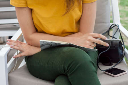 female hands with notebook