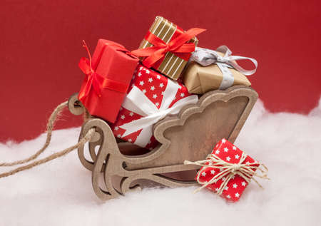 christmas sledges with pile of presents red backgroundの写真素材
