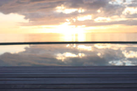 amazing sunset over the sea with dramatic clouds pool reflectionの写真素材