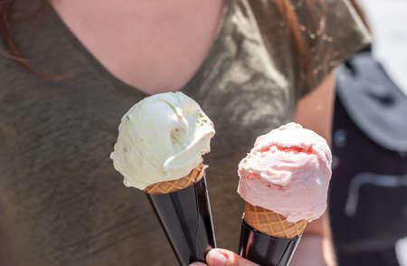 woman hands holding ice cream in waffle cone