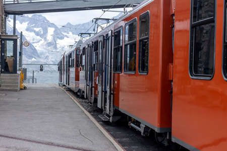 orange train high in Alps Switzerland mountains