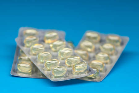 fish oil capsules blisters on blue backgroundの写真素材