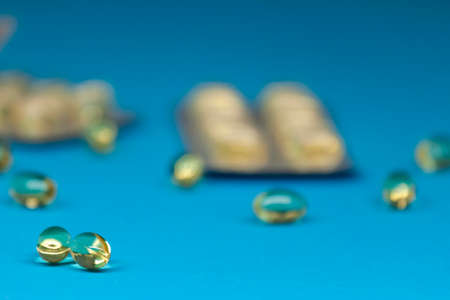 fish oil capsules blisters on blue backgroundの写真素材