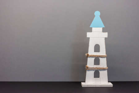 toy lighthouse on blue background with copyspaceの写真素材
